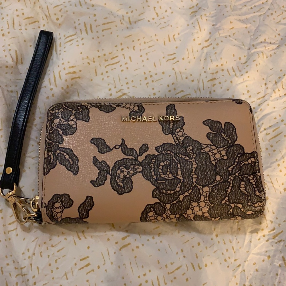 Michael Kors Wallet mide with black lace flower design.